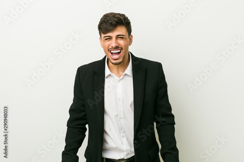 Young business hispanic man screaming very angry and aggressive.