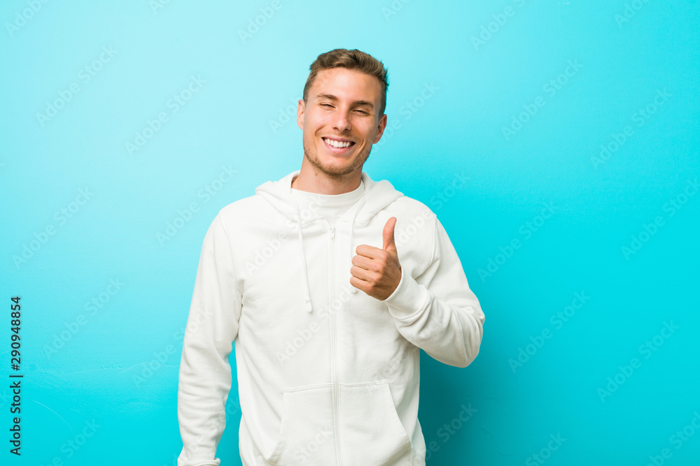 Young caucasian sport man smiling and raising thumb up Young caucasian sport man smiling and raising thumb up