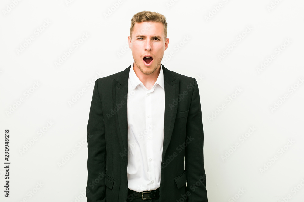 Fototapeta premium Young caucasian business man screaming very angry and aggressive.