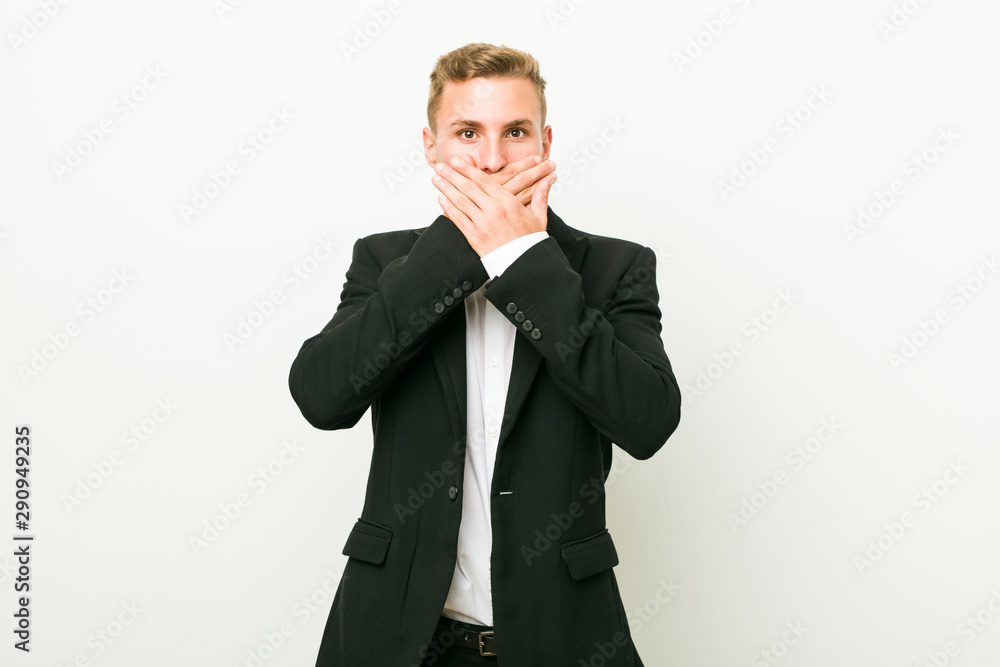 Young caucasian business man shocked covering mouth with hands. Young caucasian business man shocked covering mouth with hands.