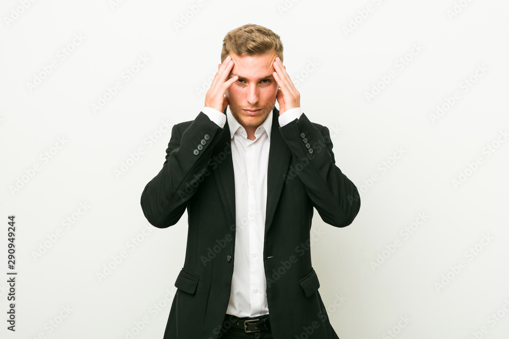 Young caucasian business man touching temples and having headache. Young caucasian business man touching temples and having headache.