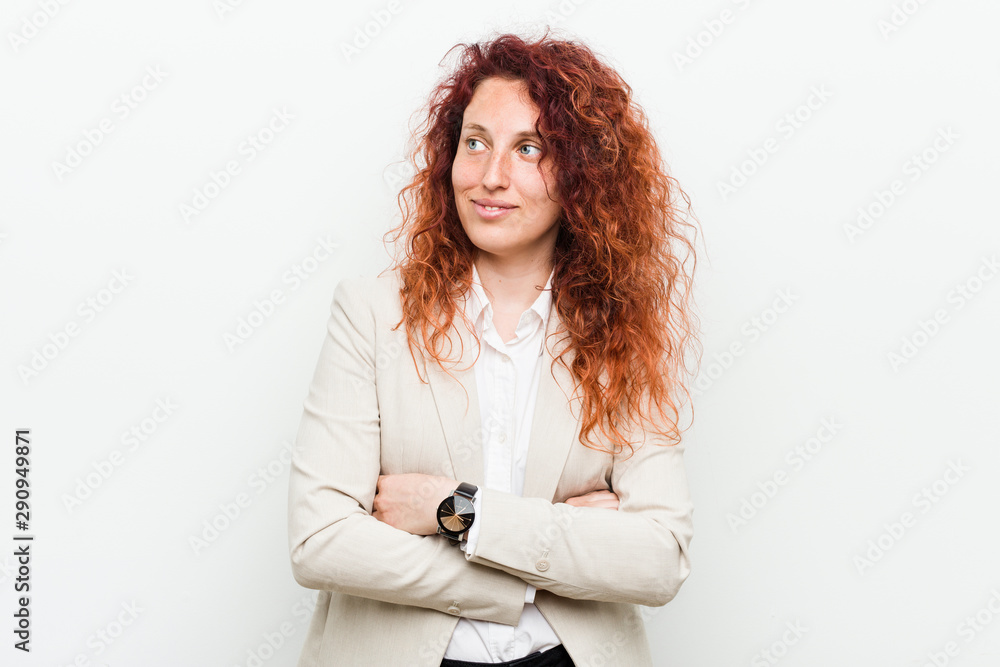 Young natural redhead business woman isolated against white background smiling confident with crossed arms. Young natural redhead business woman isolated against white background smiling confident with crossed arms.