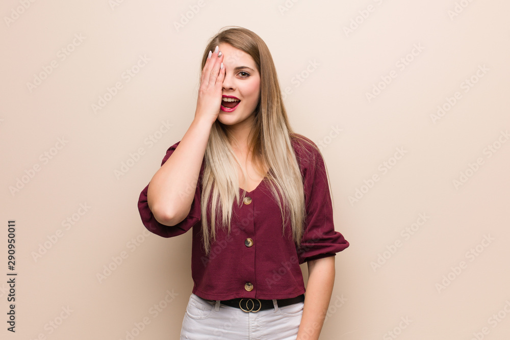 Young russian woman shouting happy and covering face with hand Young russian woman shouting happy and covering face with hand