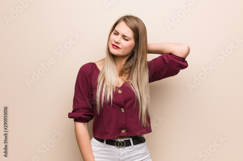 Young russian woman suffering neck pain