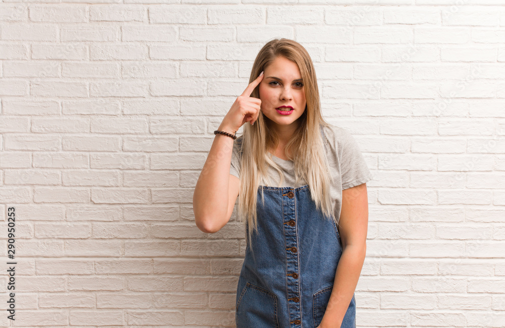 Young russian hipster woman doing a disappointment gesture with finger Young russian hipster woman doing a disappointment gesture with finger