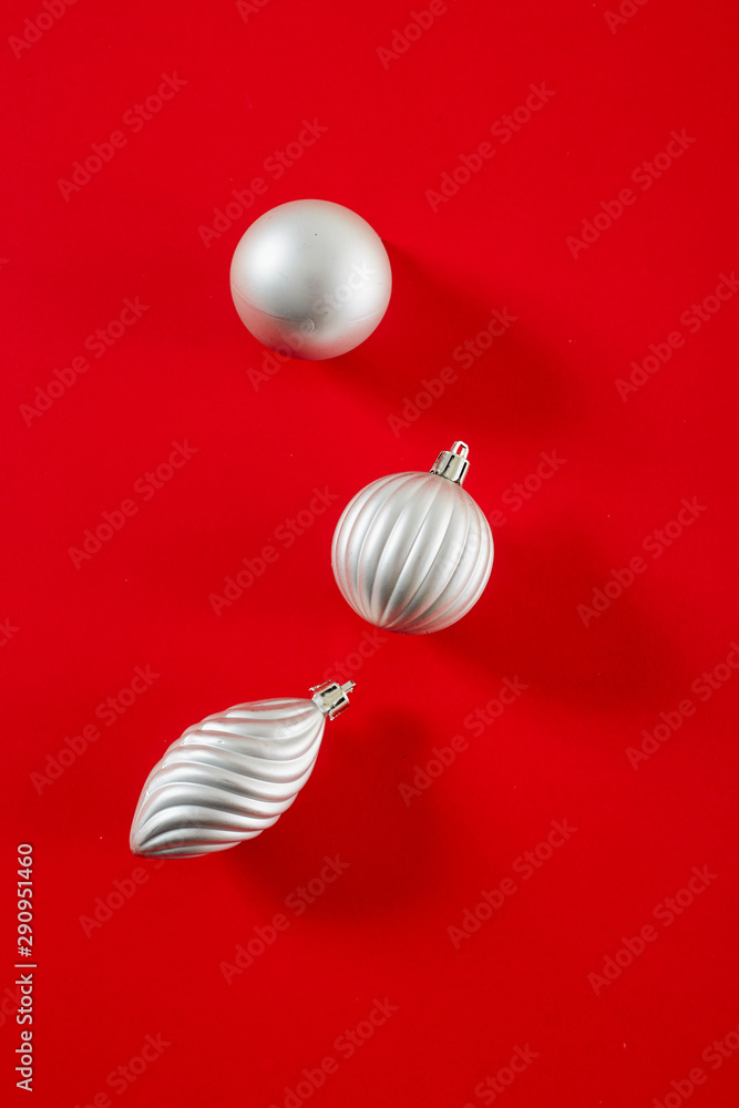 Silver Christmas Ball on red background flat lay Silver Christmas Ball on red background flat lay