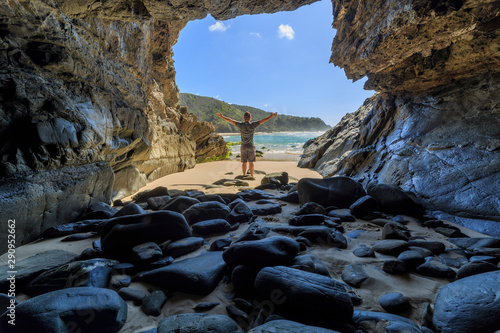 Whites Beach Cave with person, South of Byron Bay, NSW, Australia photo