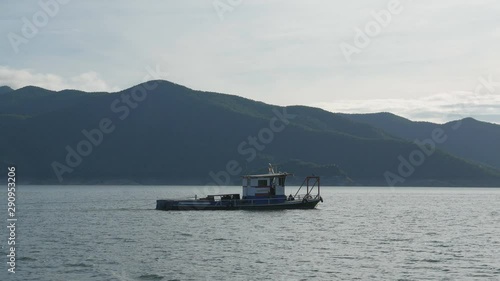 Tak, Thailand - 03 09 2019 : Boat Ride  At Bhumibol Dam Tak Province In Thailand. View of boat sail along river in dam on a sunny day and  beautiful mountain landscape .