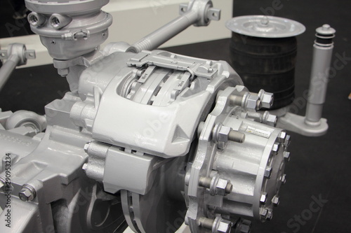 Close up truch wheel hub with brake disk, brake caliper levers and pneumatic suspension cylinder photo