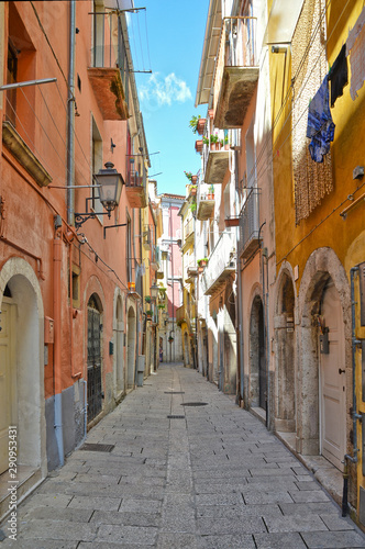 A narrow street between squares  monuments and colorful buildings in the town of Isernia  in Italy