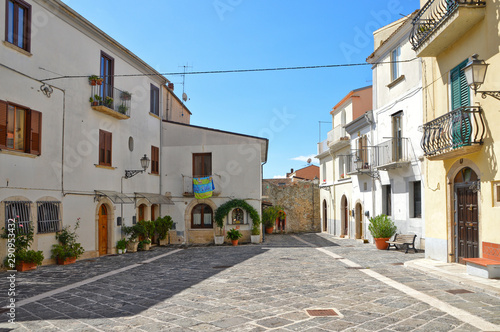 A narrow street between squares, monuments and colorful buildings in the town of Isernia, in Italy