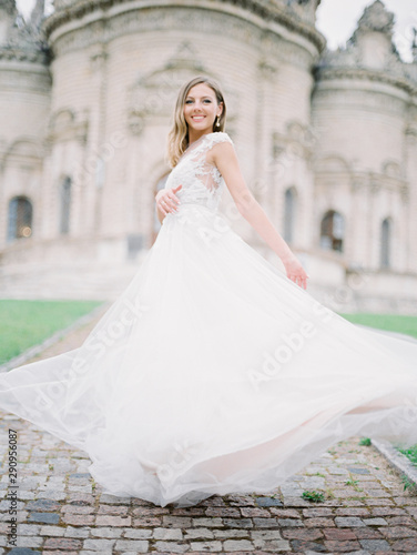 Stylish and beautiful bride portrait near the old Church. Film analog photography