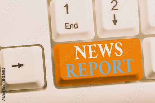 Writing note showing News Report. Business concept for spoken or written account of something that one has observed White pc keyboard with note paper above the white background photo