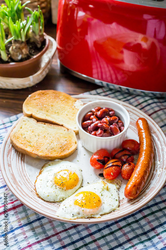 Traditional English Breakfast - Eggs, Sausage, Tomato, Toasts, Beans
