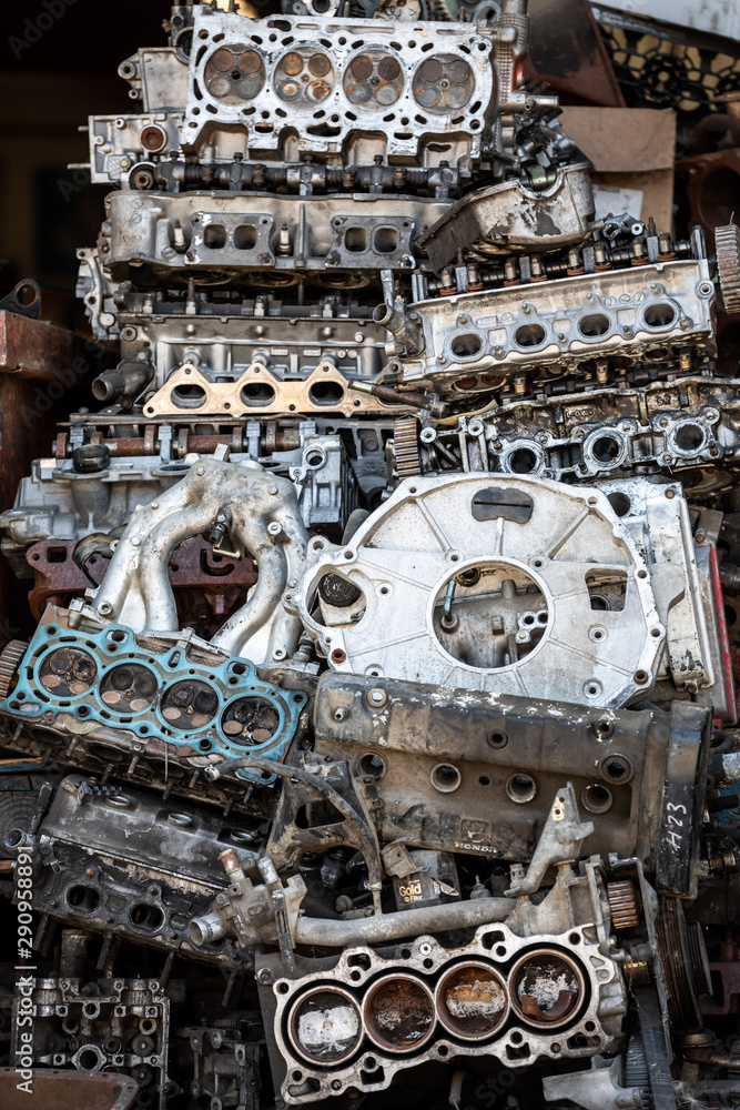 Close up of a pile of discarded car engine parts in a car repair shop