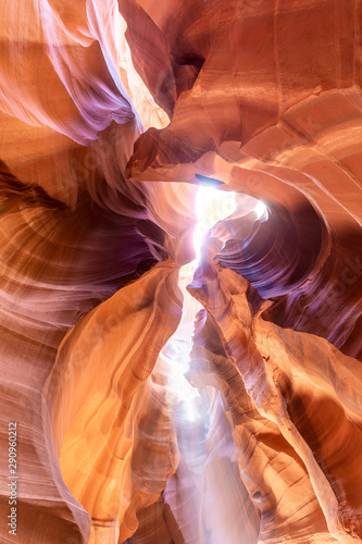 Wide angle shot of the vault of the Upper Antelope Canyon, with a beam of light shining from an opening