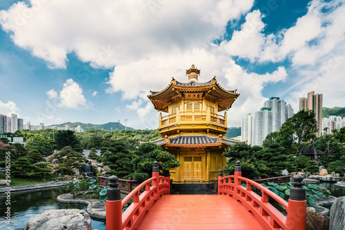 Front view the Golden pavilion temple with red bridge in Nan Lian garden, Hong Kong. Asian tourism, modern city life, or business finance and economy concept.