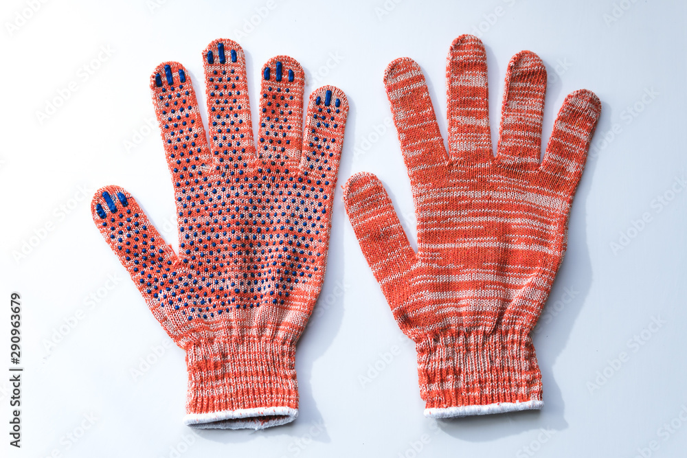 New construction gloves. knitted textile gloves on a white background. Protective equipment, safety measures. for workers, builders and installers. New construction gloves. knitted textile gloves on a white background. Protective equipment, safety measures. for workers, builders and installers.