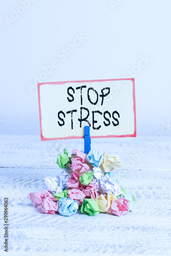 Writing note showing Stop Stress. Business concept for Seek help Take medicines Spend time with loveones Get more sleep Reminder pile colored crumpled paper clothespin wooden space photo