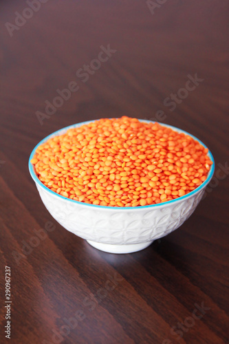 orange natural dried small lentils in a white ceramic plate