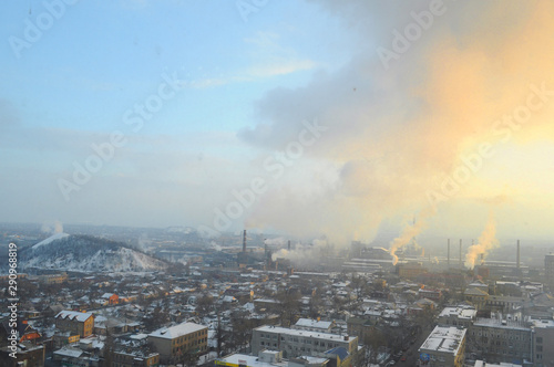 Industrial landscape with a thermal power plant in the city at sunrise
