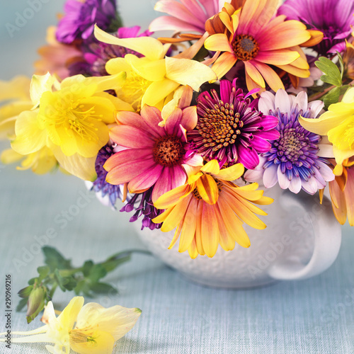 Beautiful bouquet of spring flowers in a vase on the table. Lovely bunch of flowers. Beautiful fresh flowers on a table.