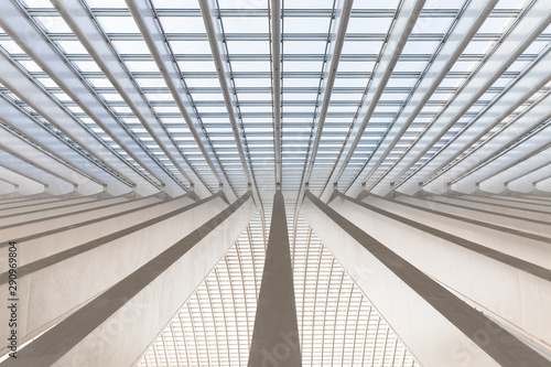 Symmetrical shot of an array of converging marble beams in a modern european trainstation photo