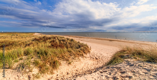 Wonderful dune beach landscape with path to the sea on the North Sea island Langeoog in Germany with sky and clouds on a beautiful summer day  Europe.