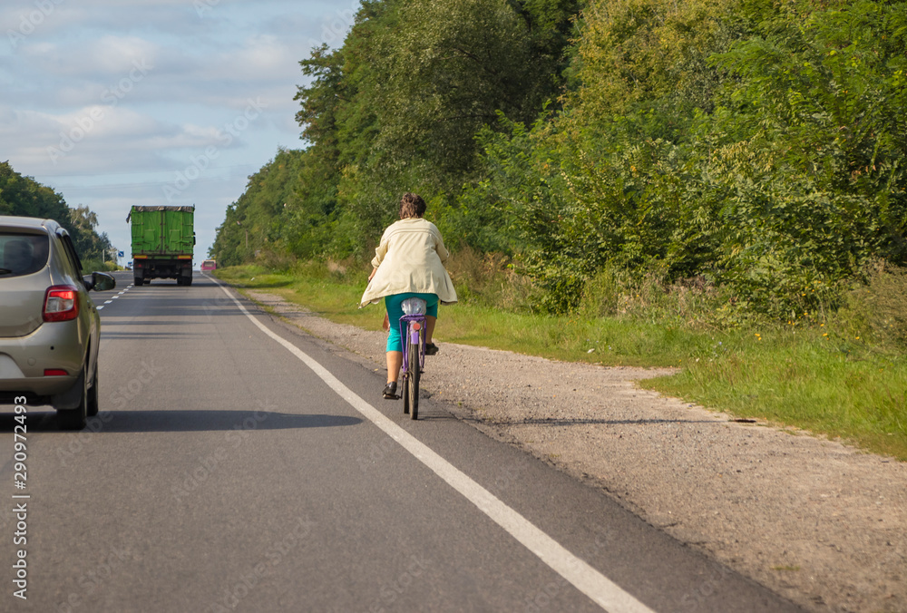 Cyclist rides on the highway on a bicycle Cyclist rides on the highway on a bicycle