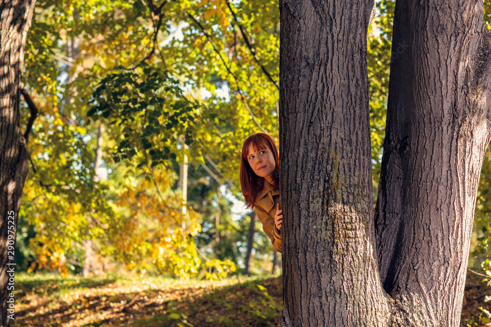 Happy woman in autumn park.Fall. Autumn Park. Autumnal Trees and Leaves in sun rays.. Happy woman in autumn park.Fall. Autumn Park. Autumnal Trees and Leaves in sun rays..