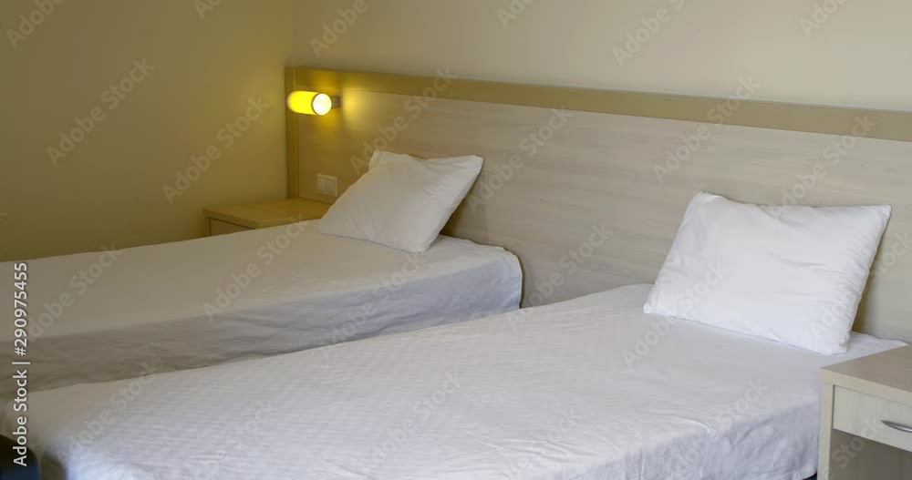 handsome businessman puts black suitcase and falls on bed handsome businessman puts black suitcase and falls on bed