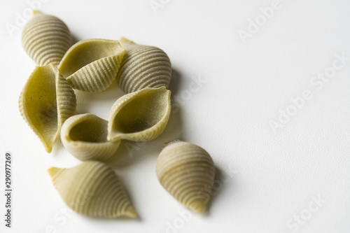 heap green shell shaped pasta on white background