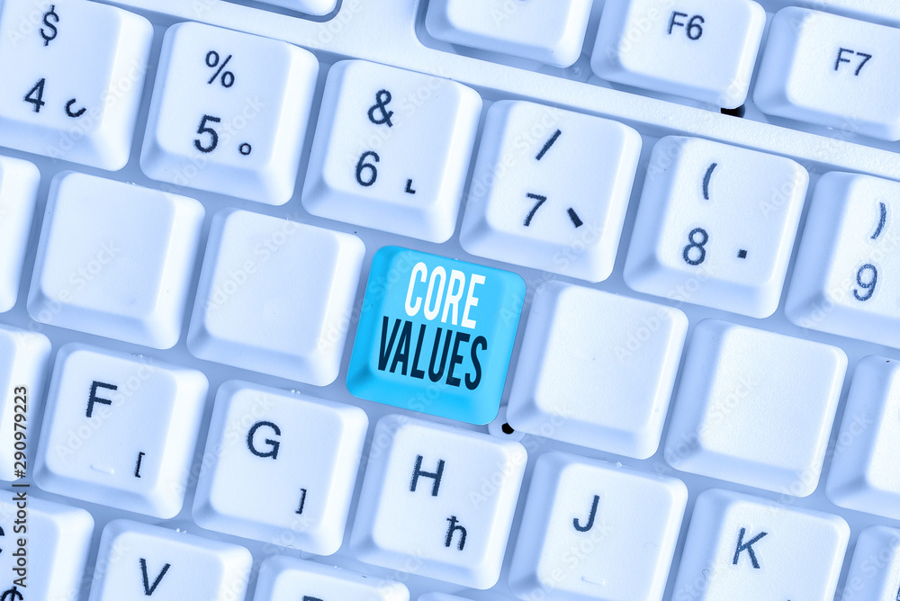 Writing note showing Core Values. Business concept for belief demonstrating or organization views as being importance White pc keyboard with note paper above the white background Writing note showing Core Values. Business concept for belief demonstrating or organization views as being importance White pc keyboard with note paper above the white background