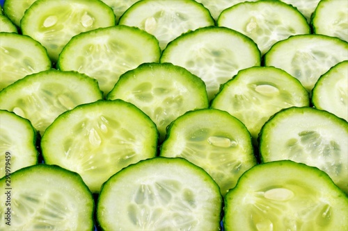 Cucumber-vegetable background. Cucumbers in cooking, add to salads, soups, snacks and sauces, salted, canned, pickled. Cucumber cosmetic, refreshes and rejuvenates the skin.