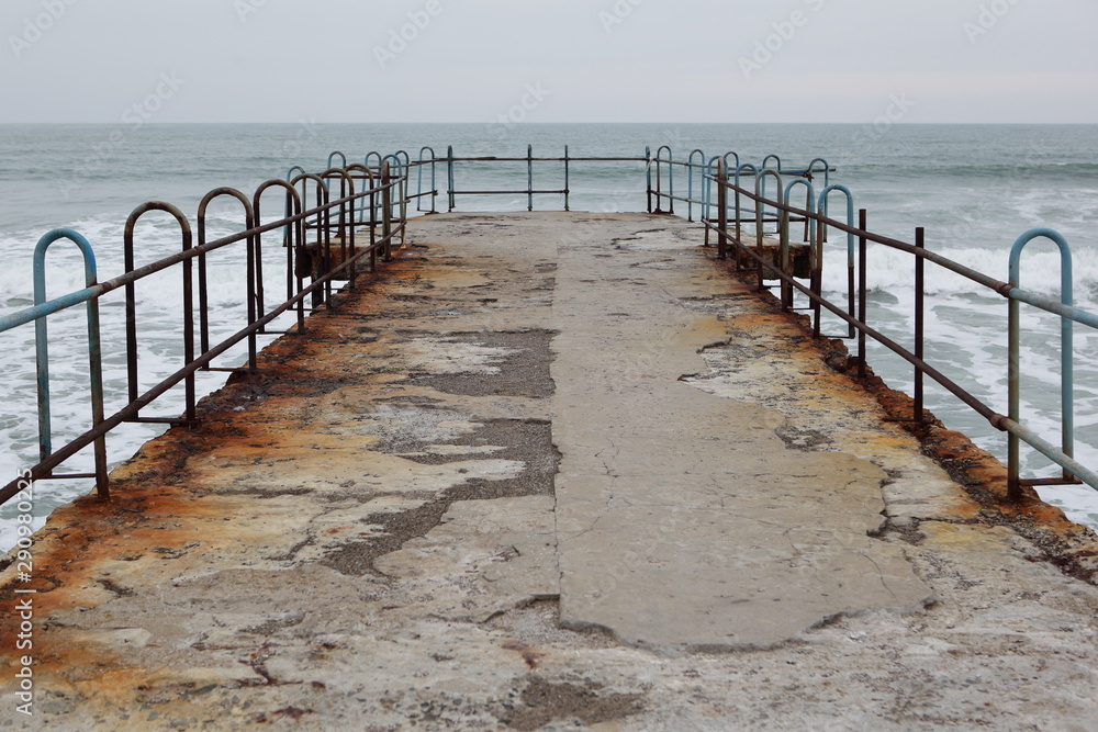 Rusty pier on the beach