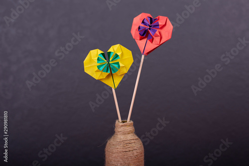 Concept of valentines day love handmade papercraft origami crafted colored paper heart close-up shot in studio
