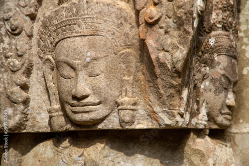 Closeup of faces carved in relief, Angkor Wat, Cambodia