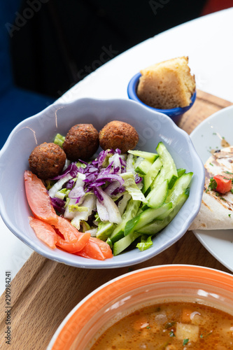 Traditional israeli salad with fresh vegetables and deep fried falafel as a part of healthy lunch
