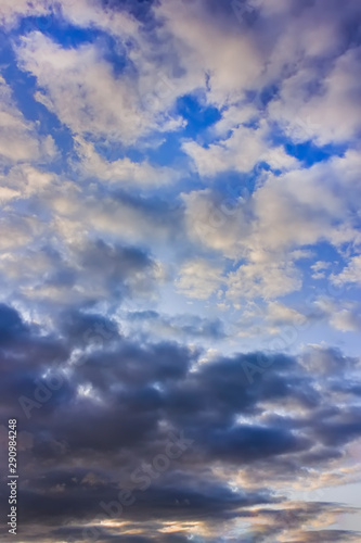 The sky at sunset. Cumulus clouds lit by the rays of the setting sun.