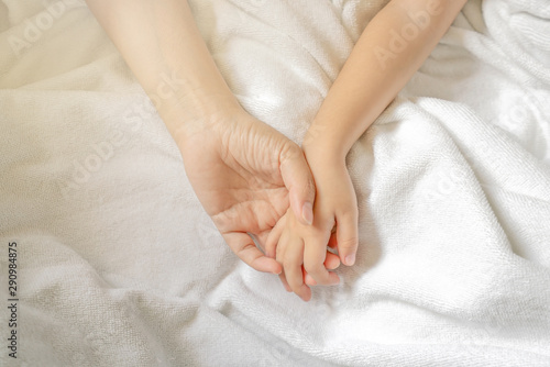 child kid and mother hands Mother holding baby white blanket