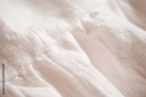 White linen textile dress closeup. Selective focus.