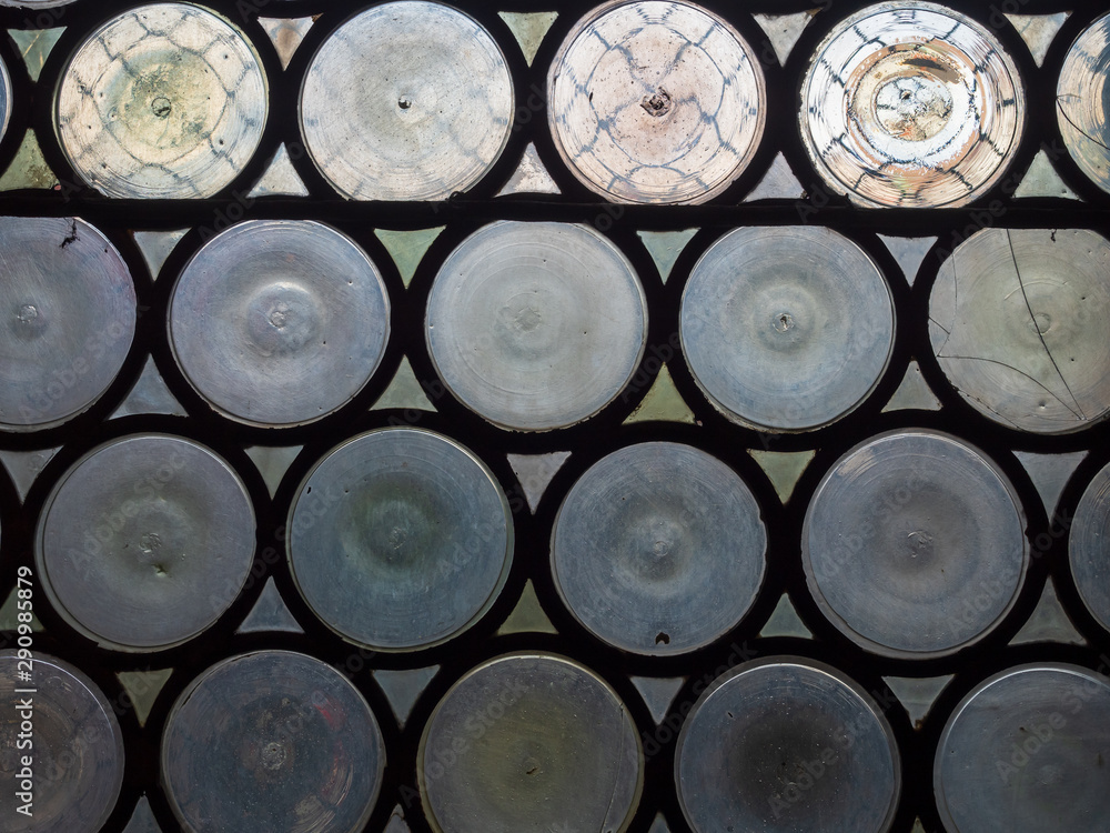 Wall of glass bottles with light in background. Wall of glass bottles with light in background.