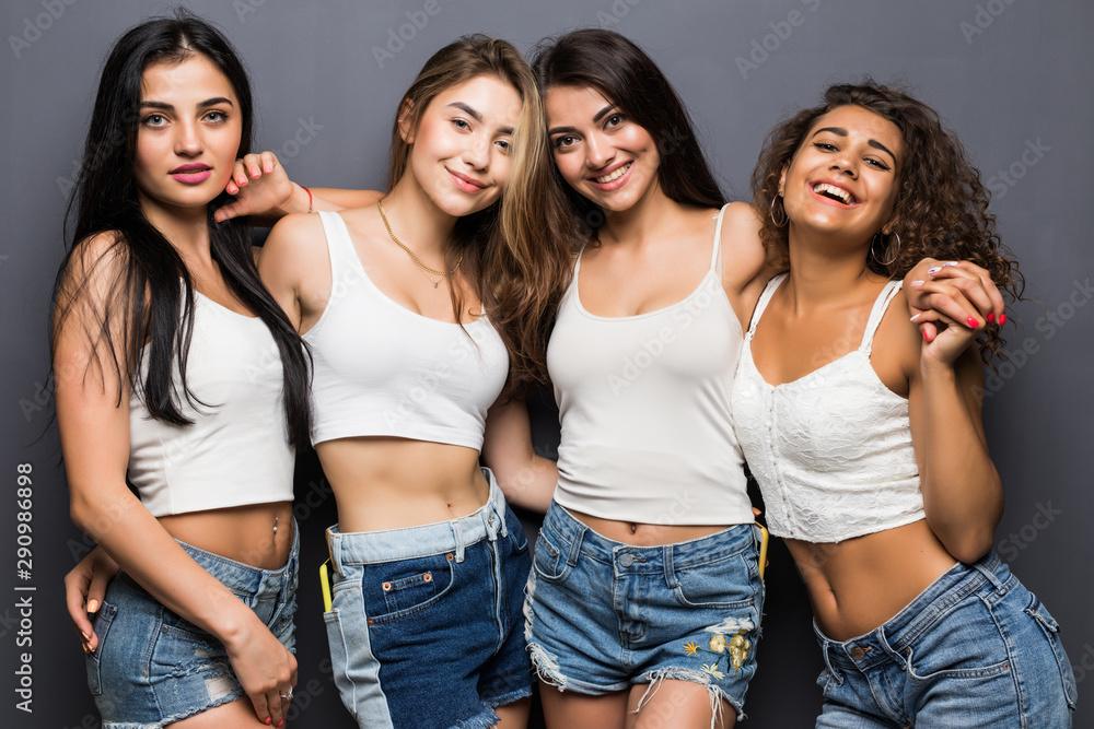 Young pretty girls standing on the gray background Young pretty girls standing on the gray background