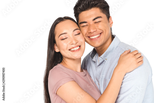 happy asian couple hugging with closed eyes isolated on white