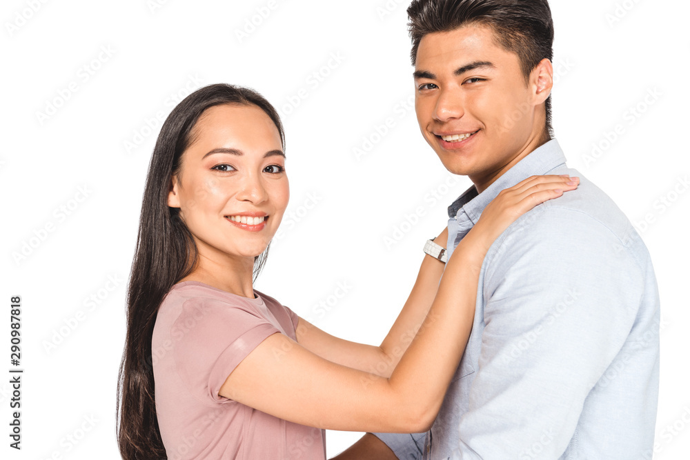 happy asian woman holding hands on shoulders of smiling boyfriend while looking at camera isolated on white happy asian woman holding hands on shoulders of smiling boyfriend while looking at camera isolated on white
