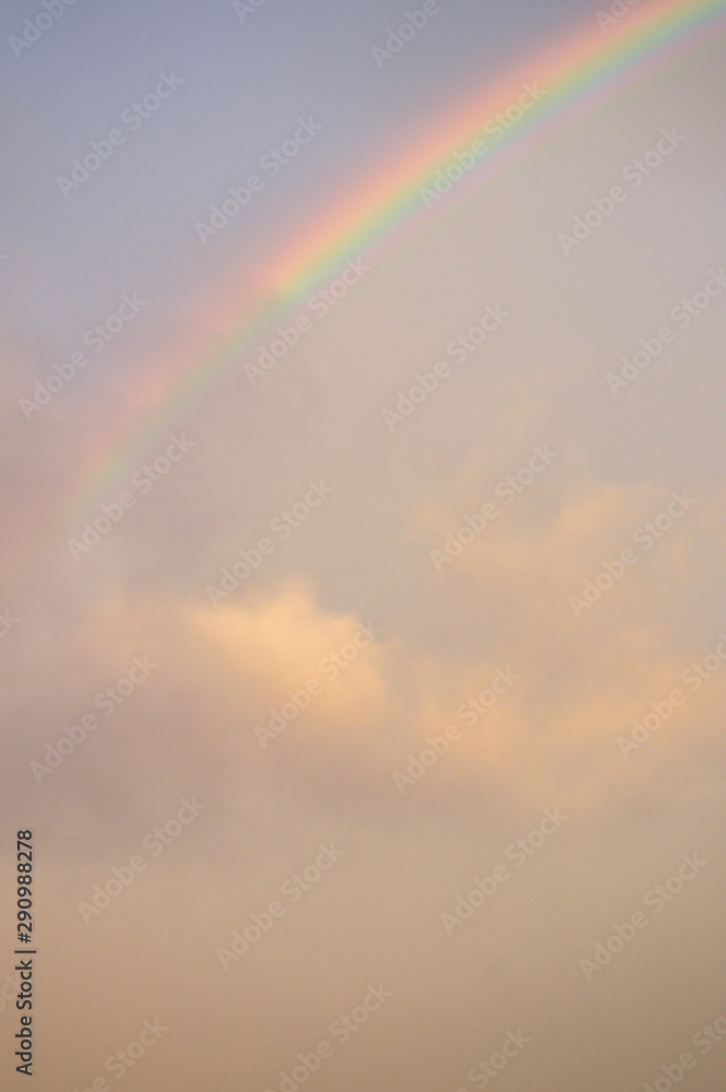 rainbow in an orange cloudy sky above a baseball stadium rainbow in an orange cloudy sky above a baseball stadium