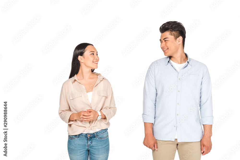 cheerful asian man and woman looking at each other isolated on white cheerful asian man and woman looking at each other isolated on white