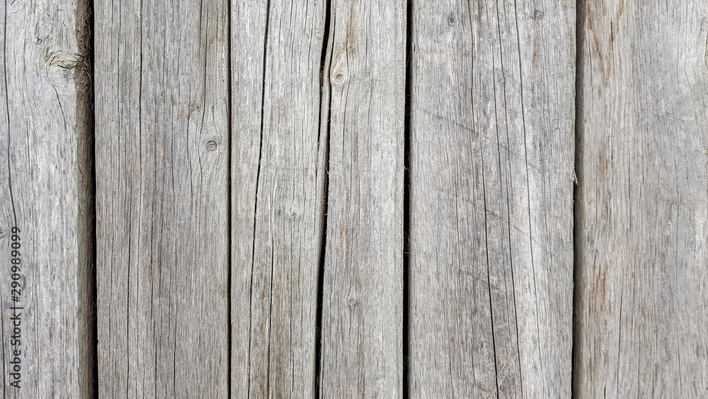 Grunge plank wood texture background. Close up of gray wooden fence panels Grunge plank wood texture background. Close up of gray wooden fence panels