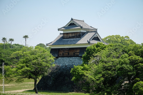 Landscape of historic fortress construction at Kumamoto Castle, overlooking trees and river.