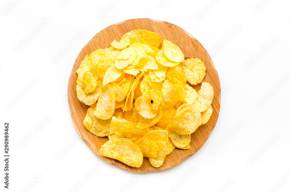 Junk food concept with heap of potato crisps on white background top view Junk food concept with heap of potato crisps on white background top view